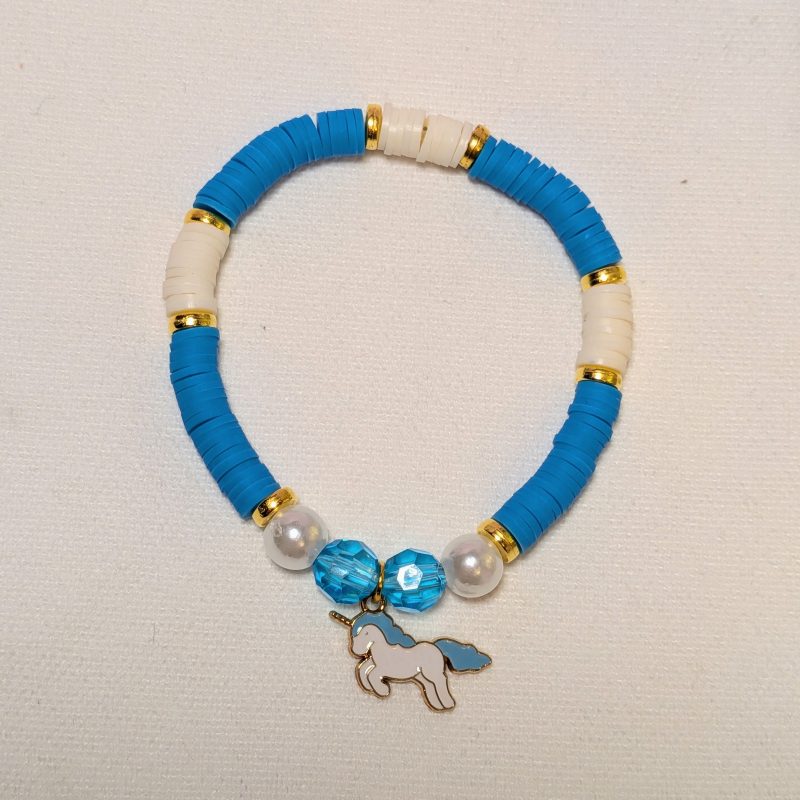 a unicorn charm with matching clay beads and gold accents