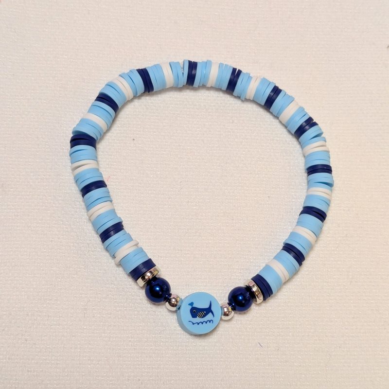 a whale bead surrounded by matching clay beads and silver accents