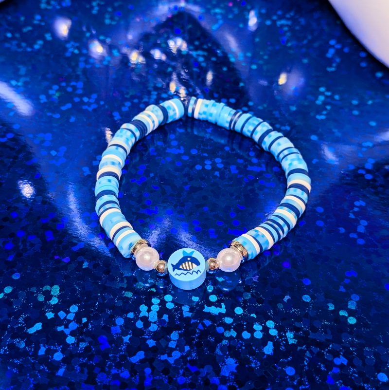 A whale centrepiece surrounded by clay beads, silver spacers, and white accent beads — view 2