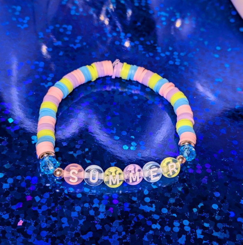 A pastel themed bracelet with the word "Summer" and matching clay beads, silver spacers, and shiny blue accent beads — view 3