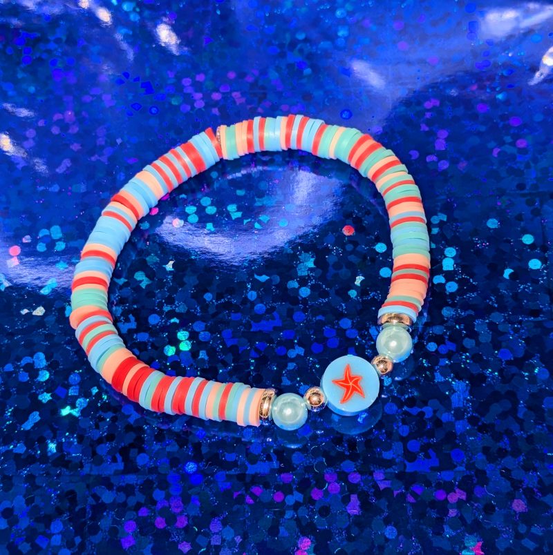 A centrepiece red starfish bead with clay beads, silver spacers, and light blue accent beads — view 3