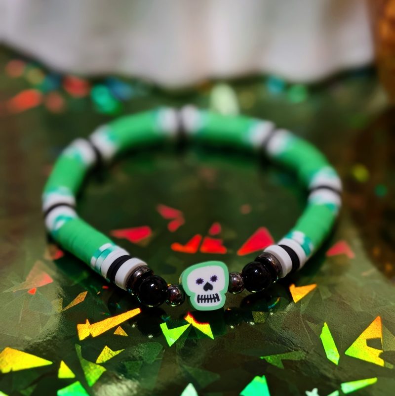 Halloween friendship bracelet with skull, black beads, and green white and black clay beads — view 2