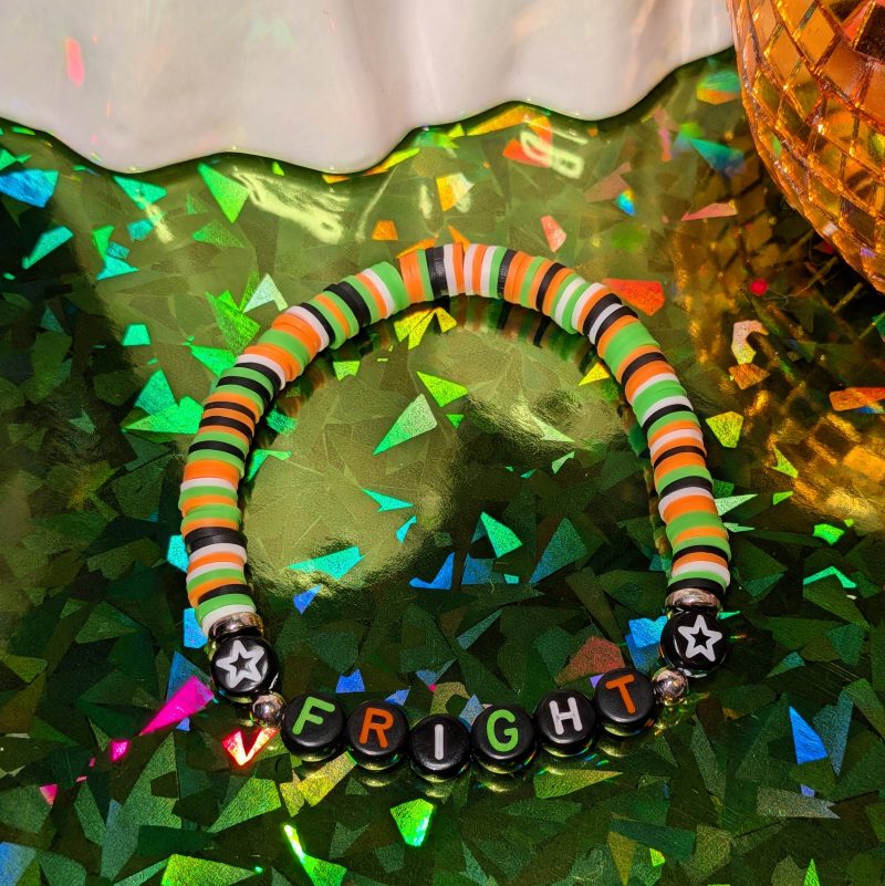 Halloween friendship bracelet that spells fright with green, white, black and orange beads — view 3