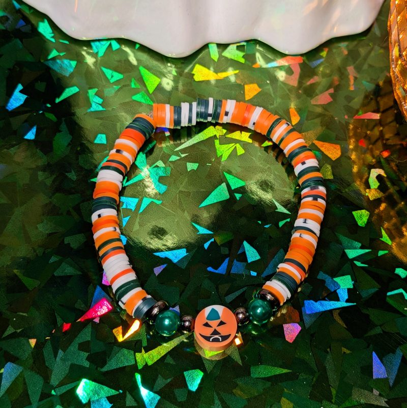 pumpkin halloween friendship bracelet with green, white, and orange beads — view 3