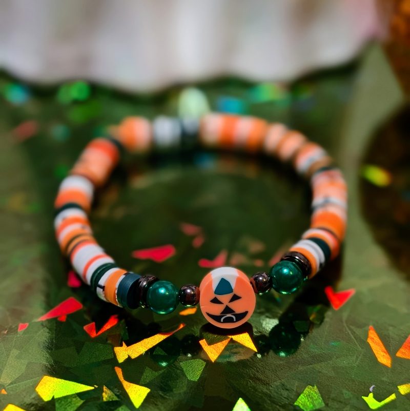 pumpkin halloween friendship bracelet with green, white, and orange beads — view 2