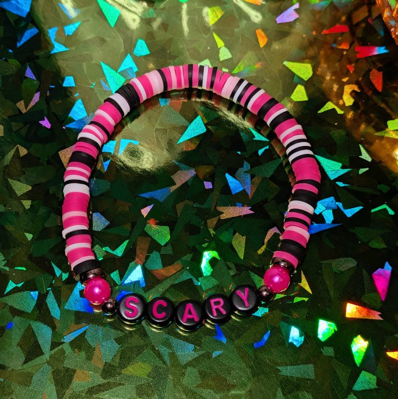 friendship bracelet that spells scary with pink, white, and black beads — view 3