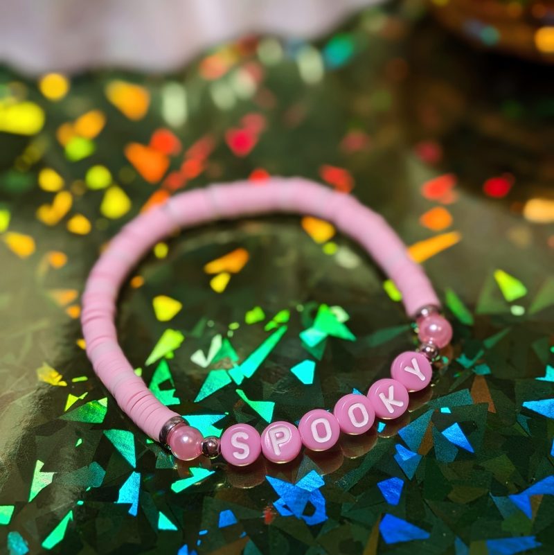 friendship bracelet that spells spooky with pink and light pink beads