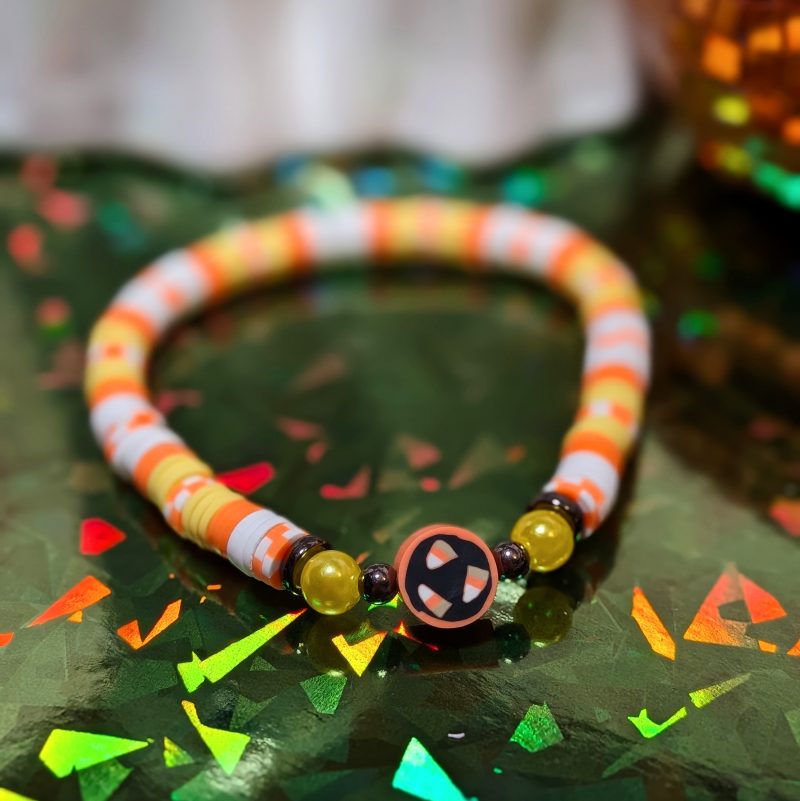 Halloween friendship bracelet with candy corn and clay beads in white orange and yellow