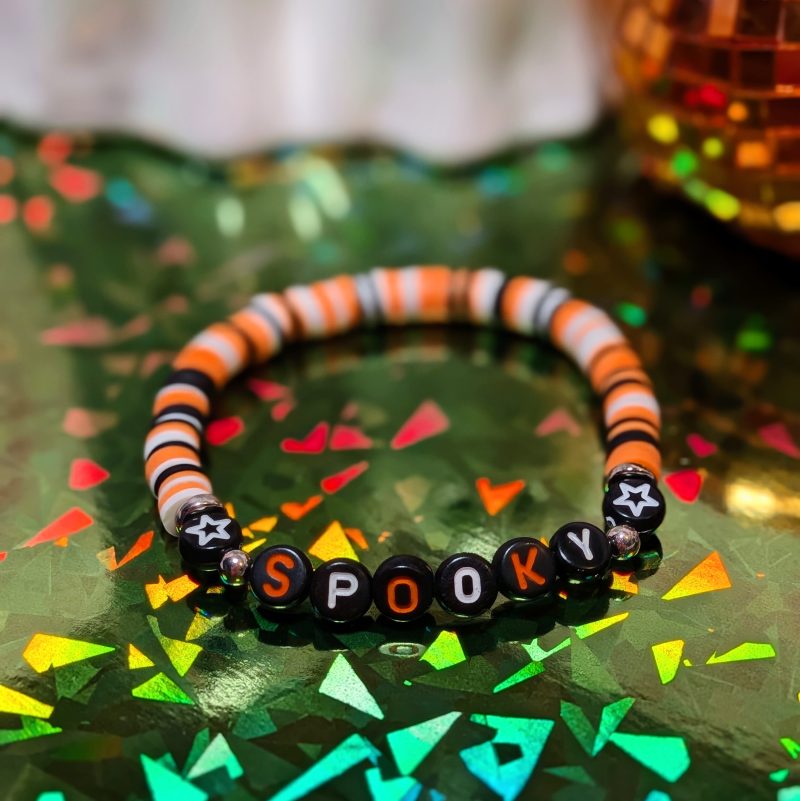 Halloween friendship bracelet spelling spooky with mixed orange white and black beads