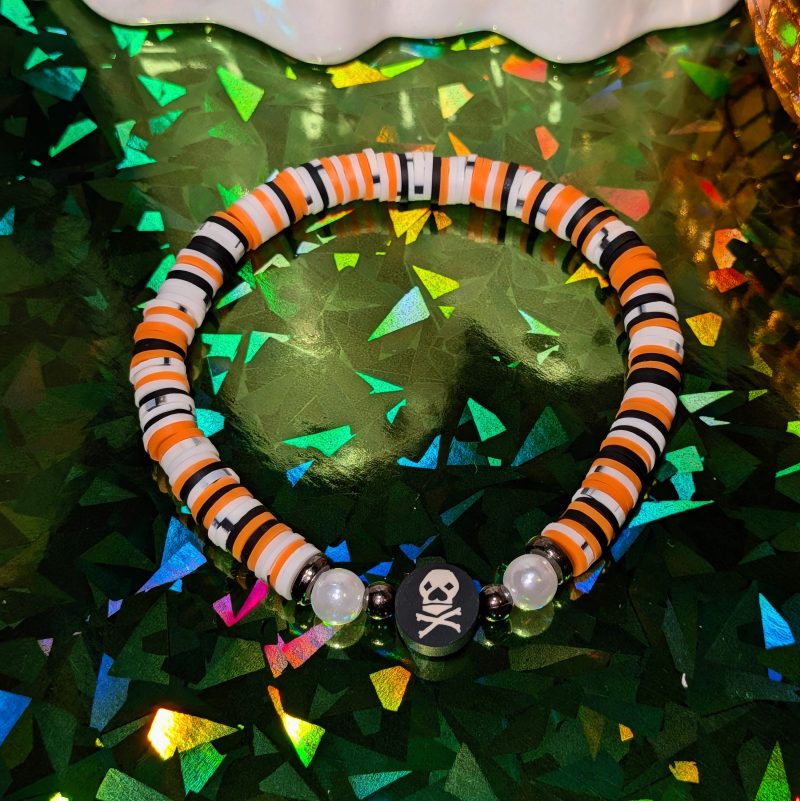 Halloween friendship bracelet with skull bead with mixed orange white and black beads — view 3